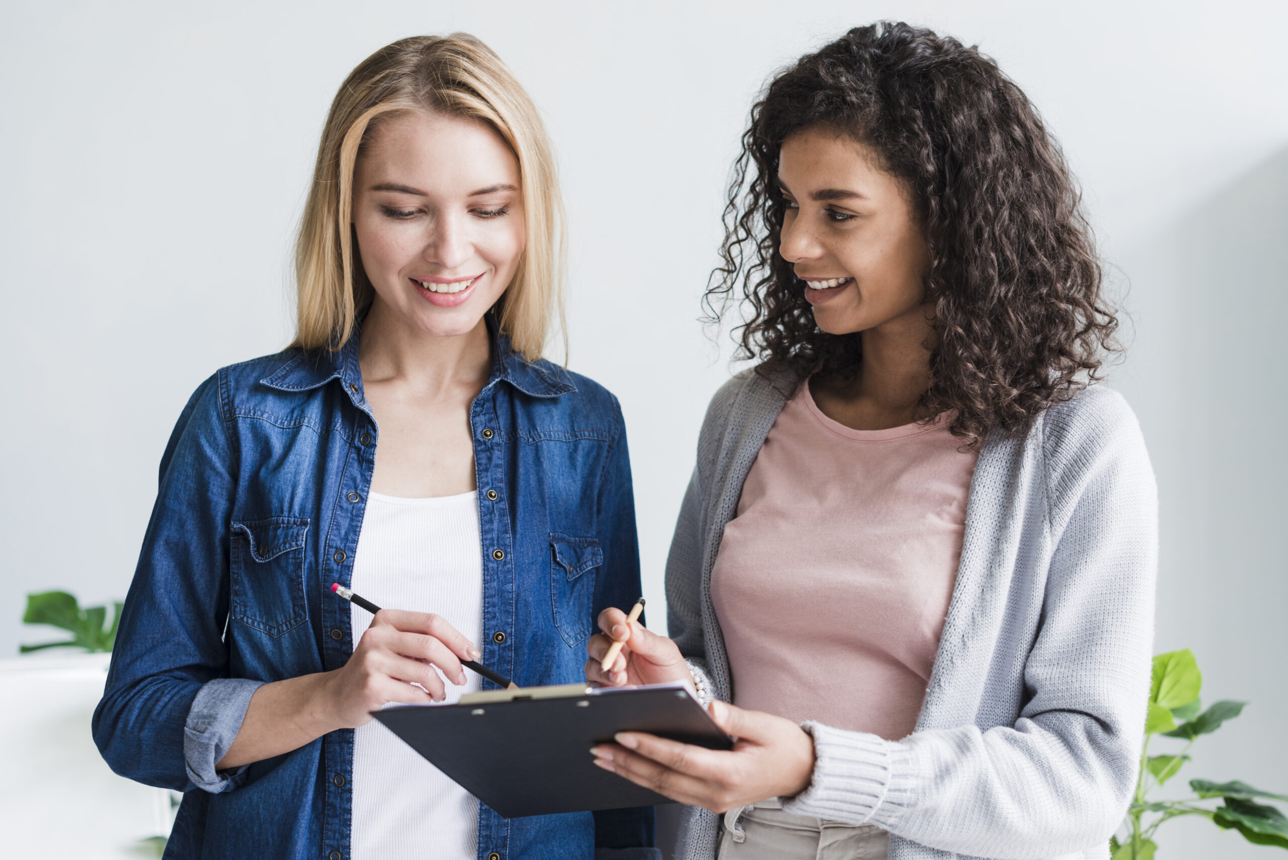 employees-discussing-writings-clipboard